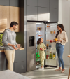 A family in a kitchen with a Beko refrigerator